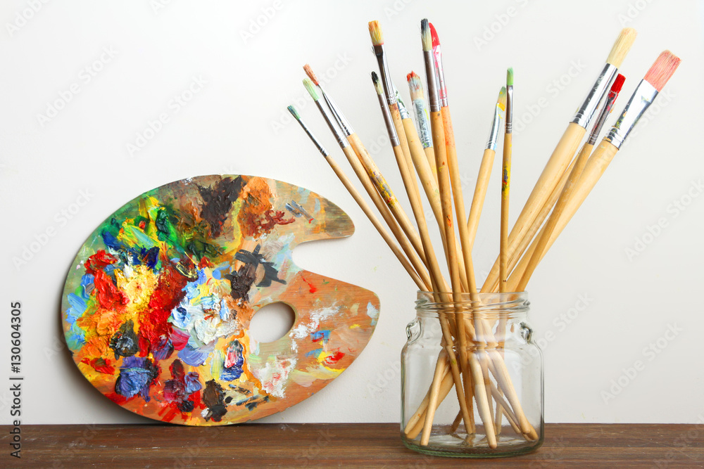 Fototapeta premium Wooden art palette and brush on the table.