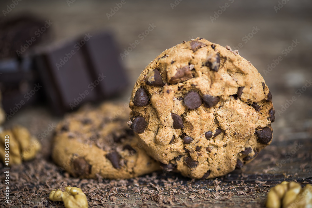 Chocolate Chip Cookies and Walnuts on Wooden Rustic Background Chocolate Chip Cookies and Walnuts on Wooden Rustic Background