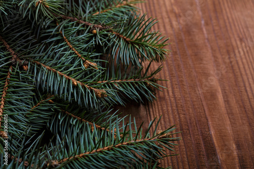 Christmas background with xmas tree and sparkle bokeh lights on wooden canvas background. Merry christmas card. Winter holiday theme. Happy New Year. Space for text. Happy Holidays