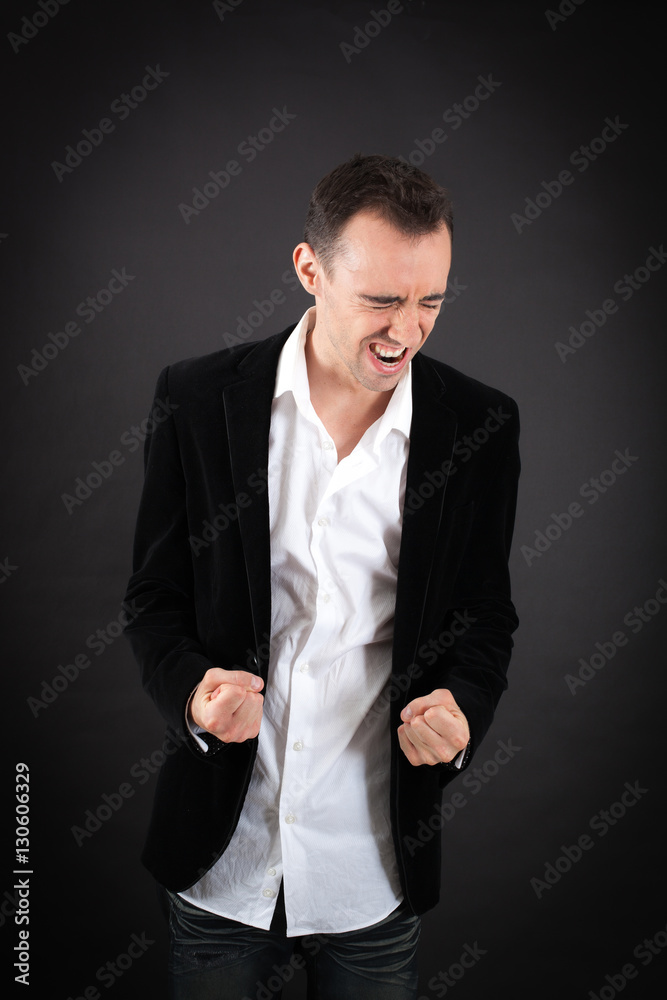Handsome man doing different expressions in different sets of clothes: arms raised Handsome man doing different expressions in different sets of clothes: arms raised
