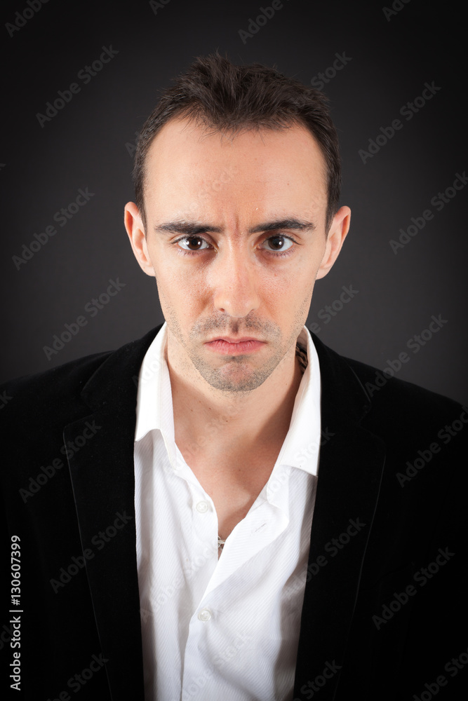Obraz premium Handsome man doing different expressions in different sets of clothes: angry