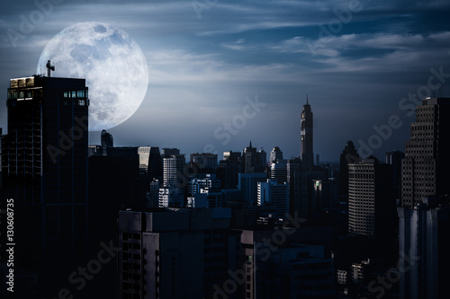 Obraz na płótnie Silhouettes of skyscrapers different construction with backgroud of a full moon w salonie
