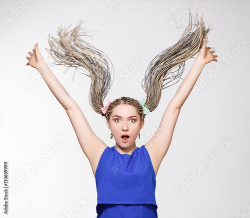 Surprised young woman long dreads. Modern hairstyles. photo