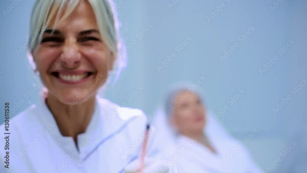 The beautician with syringe smile in the camera The beautician with syringe smile in the camera