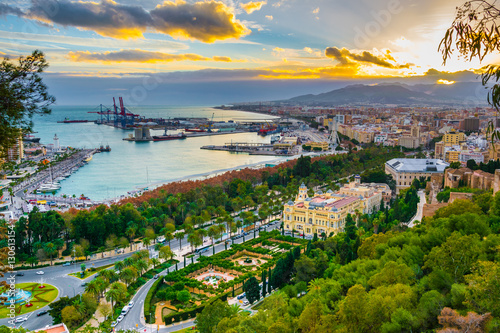 aerial view of malaga taken from gibralfaro castle including port of malaga, alcazaba castle and the cathedral of malaga during sunset