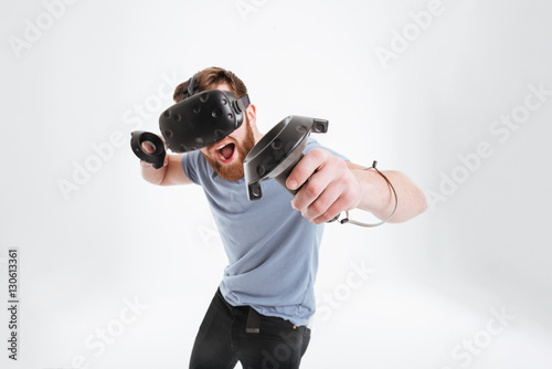 Bearded happy man wearing virtual reality device