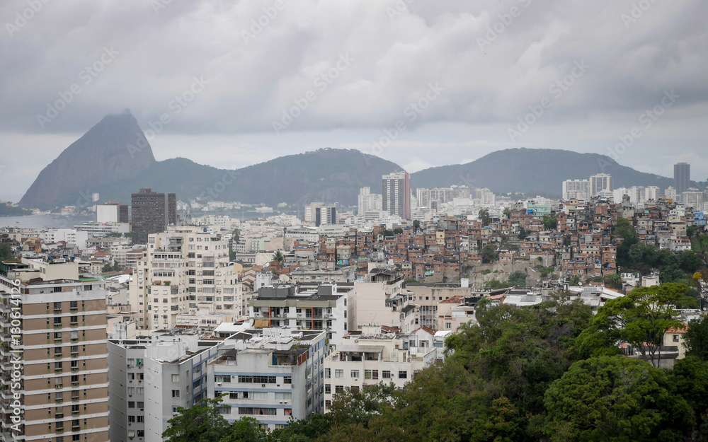 Rio de Janeiro, Brazil. A crowded view over Rio with affluent apartment blocks near the sea and poor favelas on high ground.