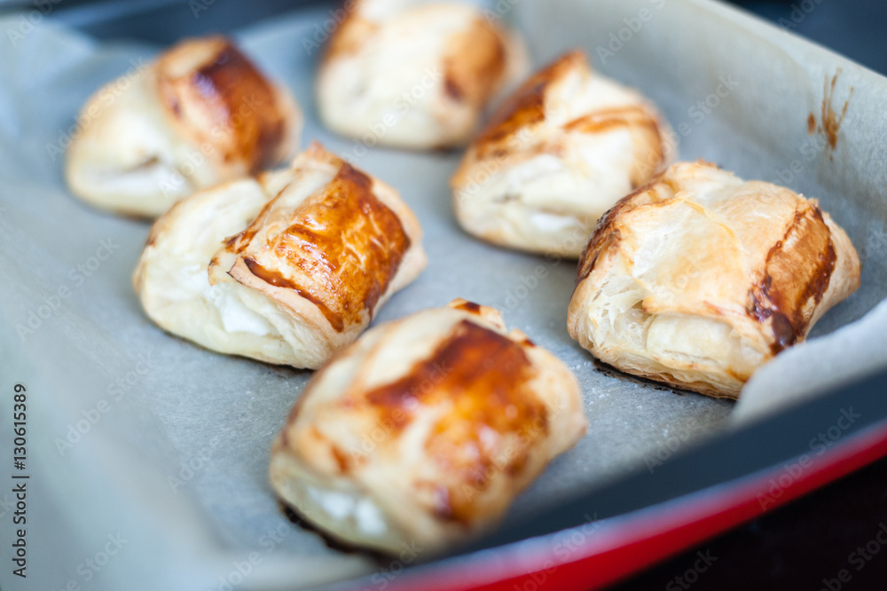Freshly baked cheese rolls in a pan