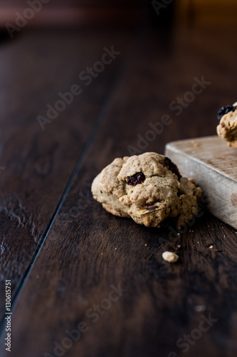 Chocolate chip cookie on wooden surface.
