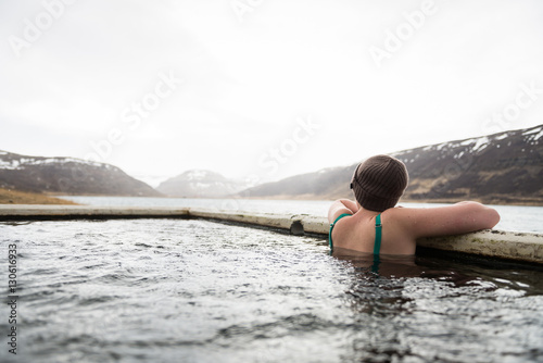 Beautiful girl in a hot pot in Iceland during winter