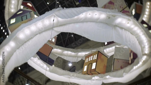 Toy town for New Year's and Christmas decorations in the malls, in the central part. Decorations hang ceiling.