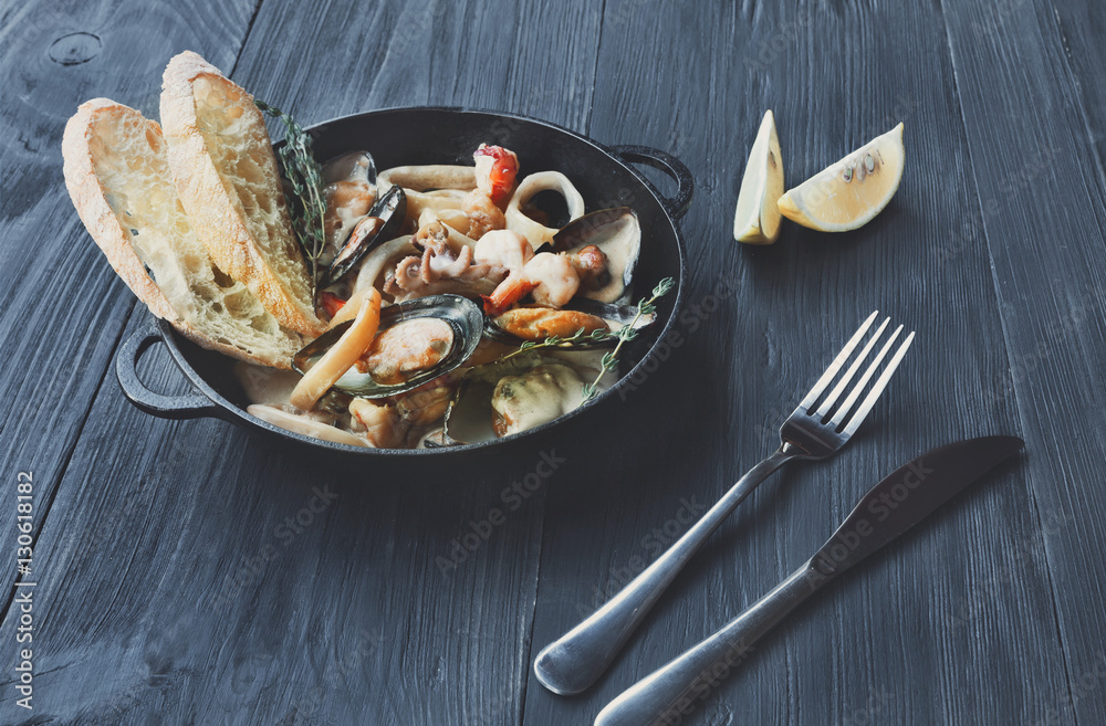 Seafood Stew in Saucepan on dark wood background Seafood Stew in Saucepan on dark wood background