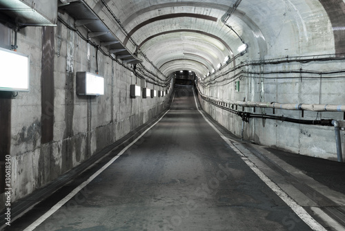 Fototapeta Naklejka Na Ścianę i Meble -  Long road tunnel with lighting. Empty car in tunnel.