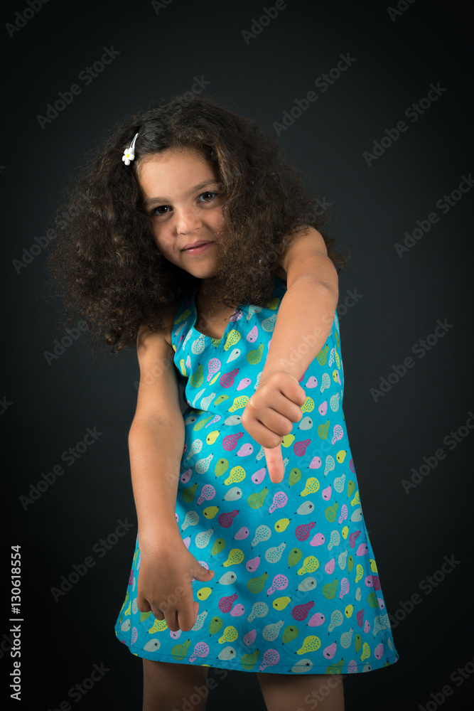 Obraz premium Beautiful girl doing different expressions in different sets of clothes: thumbs down
