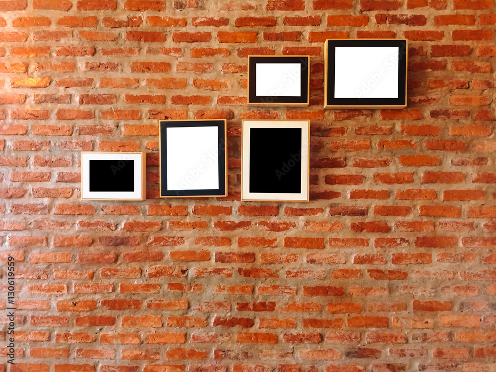Fototapeta premium Brick wall with photo frames,vintage style.