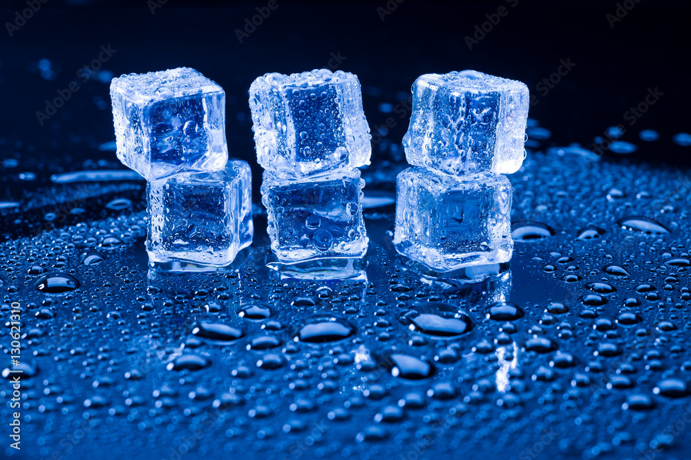 Wet ice cubes and water drop on blue background. Wet ice cubes and water drop on blue background.
