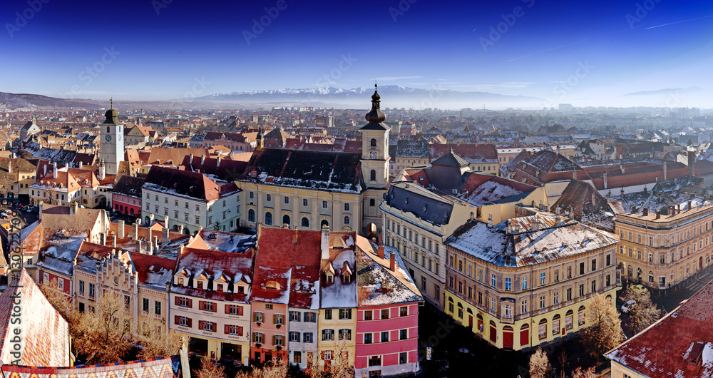 Fototapeta premium Sibiu panorama in Transylvania, Romania. HDR photo. Panoramic view from above with the Fagaras mountains visible in the back.