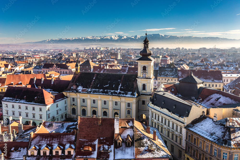 Sibiu, in the center of Transylvania, Romania. View from above with the Fagaras Mountains in the back. HDR photo. City also known as Hermannstadt
