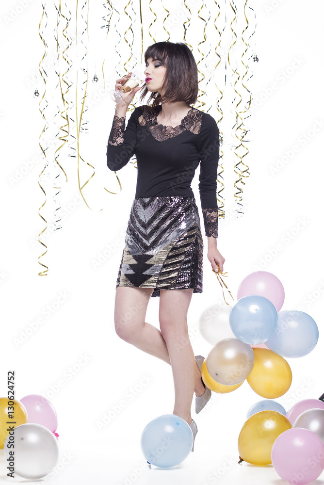 Fototapeta premium Beautiful woman elegantly dressed drinking champagne at the event