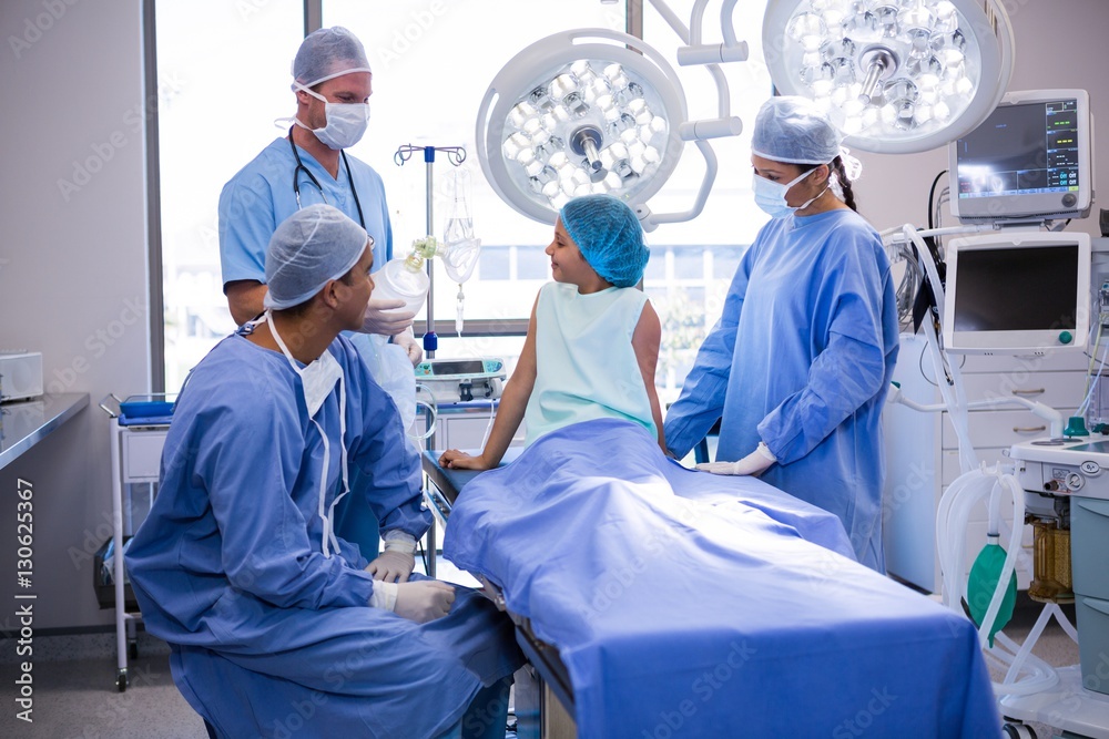 Doctor interacting with patient in operation room Doctor interacting with patient in operation room