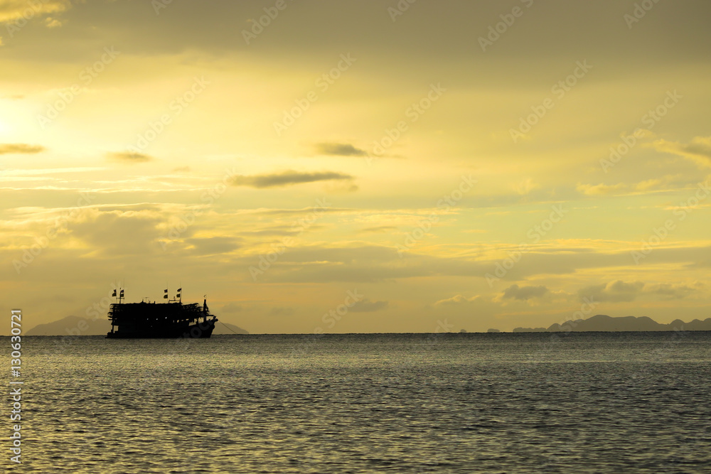 the silhouette of boat in the sea with dramatic tone