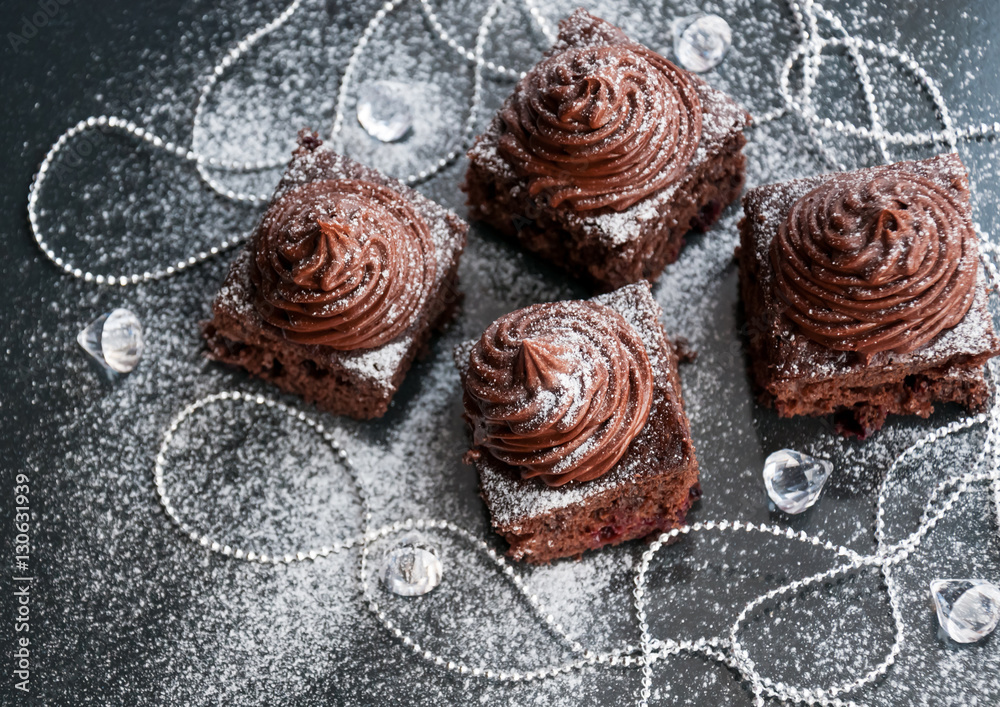 Brownie cake bites with chocolate cream and berries - dessert idea for holiday party on dark Christmas background, blank space for recipe text Brownie cake bites with chocolate cream and berries - dessert idea for holiday party on dark Christmas background, blank space for recipe text