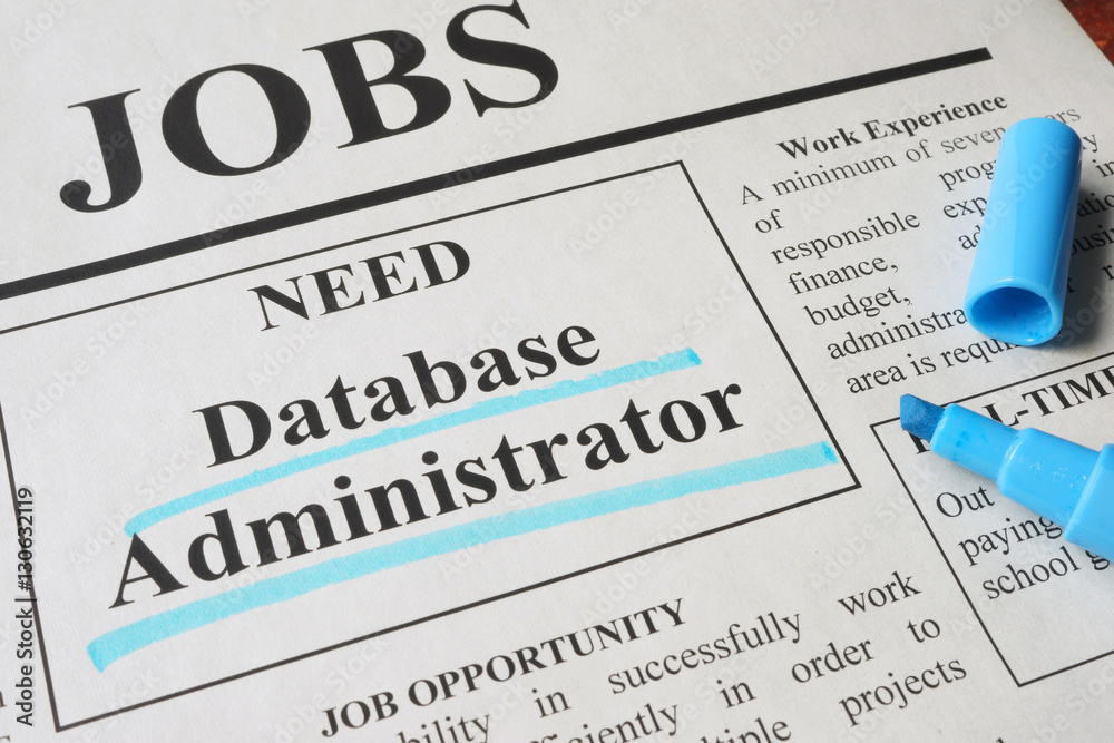 Newspaper with ads for vacancy database administrator. Employment concept.