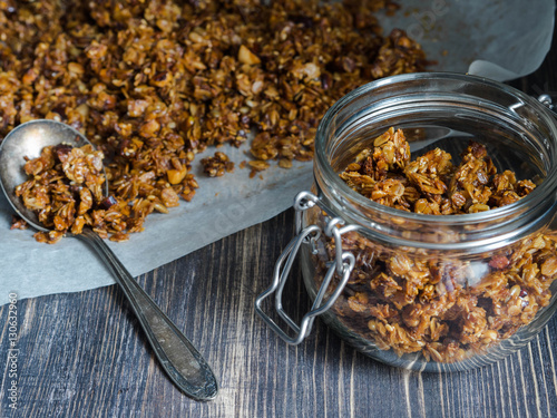 Open glass jar with homemade granola 
 photo