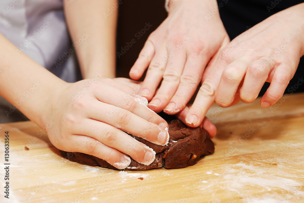 children's hands making christmas cookies with metal cutter. children's hands making christmas cookies with metal cutter.