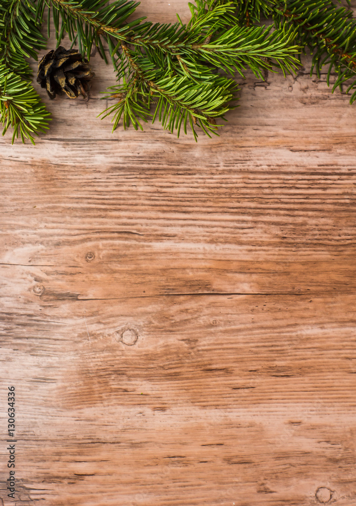 christmas wooden background with pine (christmas tree) branches and cones