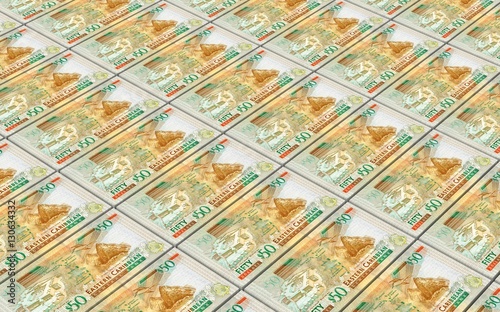 Eastern Caribbean dollar bills stacked background. 3D illustration.