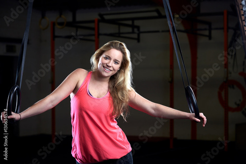 Portrait Of Young Woman In Gym With Olympic Rings