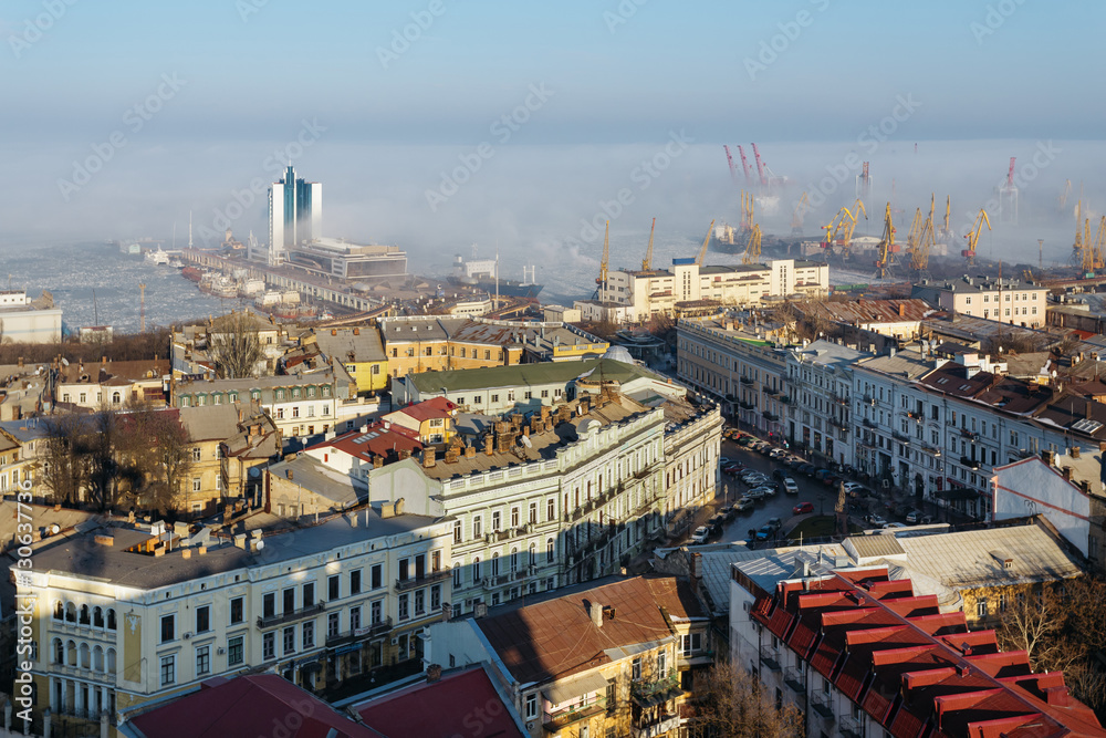 top view of the center of the historical part of Odessa and the Odessa sea port on a sunny day with fog.