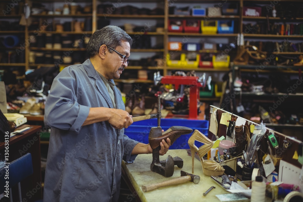 Shoemaker hammering on a shoe Shoemaker hammering on a shoe