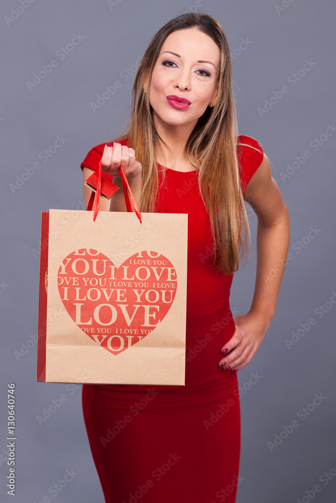 Smiling woman in red dress with shopping bags Smiling woman in red dress with shopping bags
