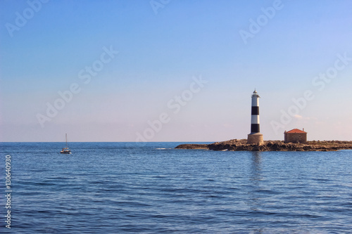 Small lighthouse and a sailboat on Formentera, Ibiza, Balearic I