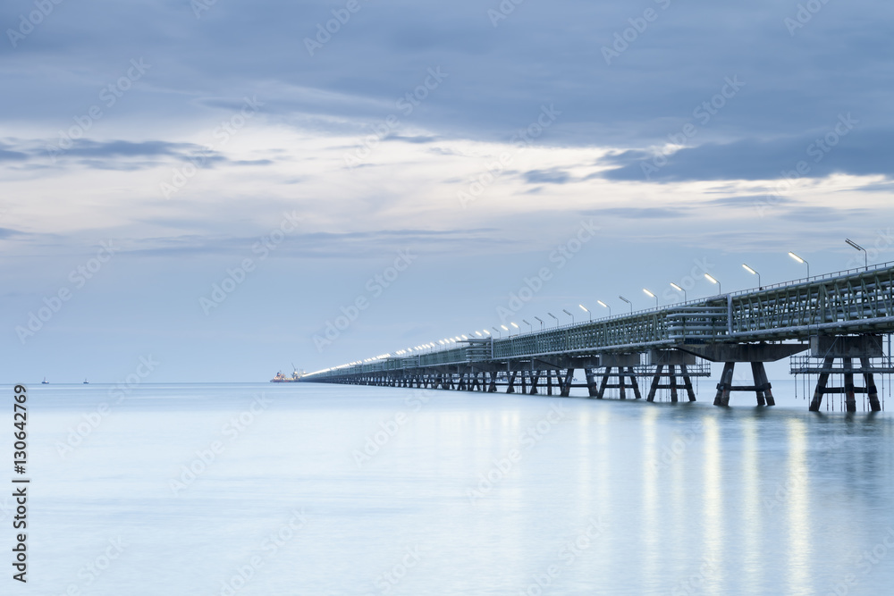 Fototapeta premium Long pipeline with Gas transport ship on port