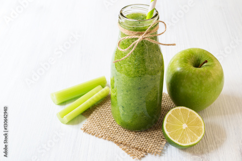 Healthy green celery smoothie in bottle