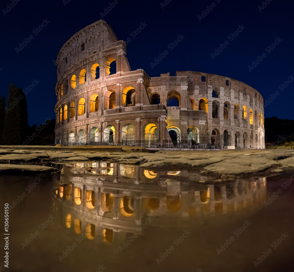 Rome Italy Colosseum with full reflection at night with lights and no people, Roman panorama