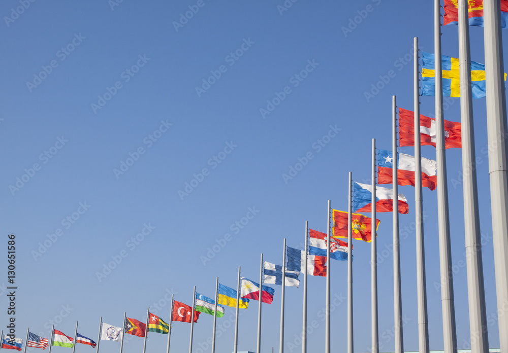 Flags of different countries on the flagpole