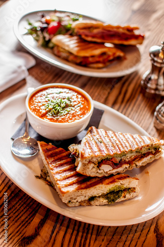 Club sandwich pressed panini with chicken, tomato, cheese and a side of tomato soup