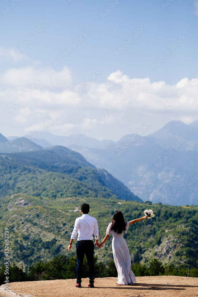 honeymoon wedding couple travel mountains back view