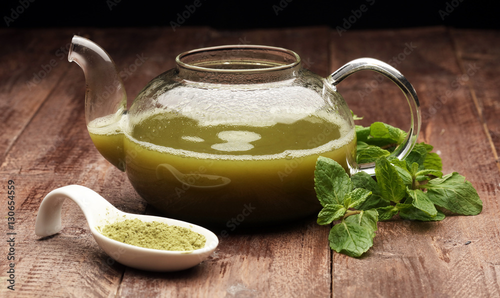 Cup of tea and mint leaf on a wooden background - hot water in a tearoom place Cup of tea and mint leaf on a wooden background - hot water in a tearoom place