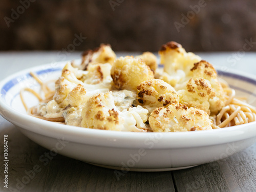 Roasted cauliflower over whole grain spaghetti.