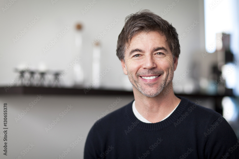 Obraz premium Portrait Of A Mature Handsome Man Smiling At The Camera. Home. Kitchen