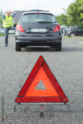 warning triangle behind stalled car