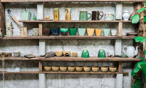 Ceramic cup on shelf cement background © Nuthasak