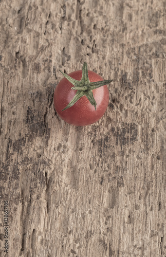 Ripe tomato on wooden table