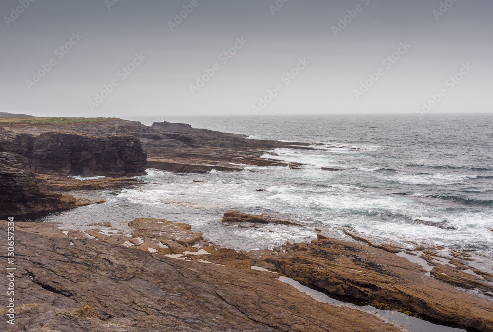 Waves crashing on large rocks at Hook Head, Wexford, Republic of Ireland.