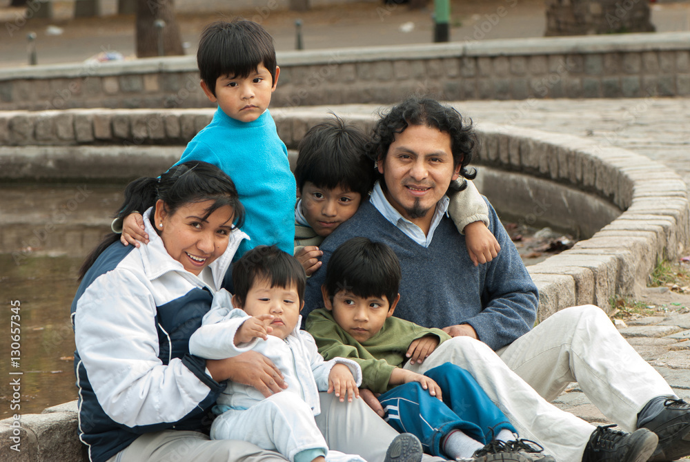 Happy Latin family sitting in the street Happy Latin family sitting in the street